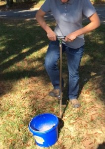 Woman taking soil sample.