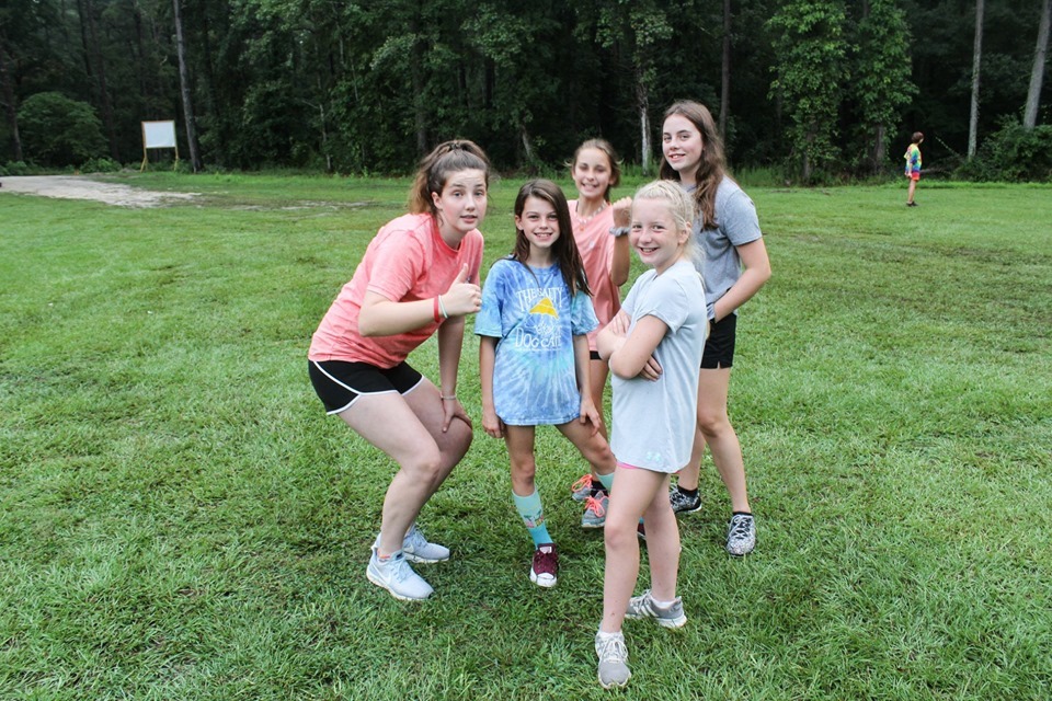 Five campers smile while on the field at Millstone 4-H Camp.