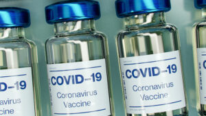 Generic COVID-19 vaccine vials are arranged in a row.