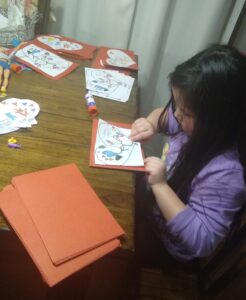 Ava T. works on cards.