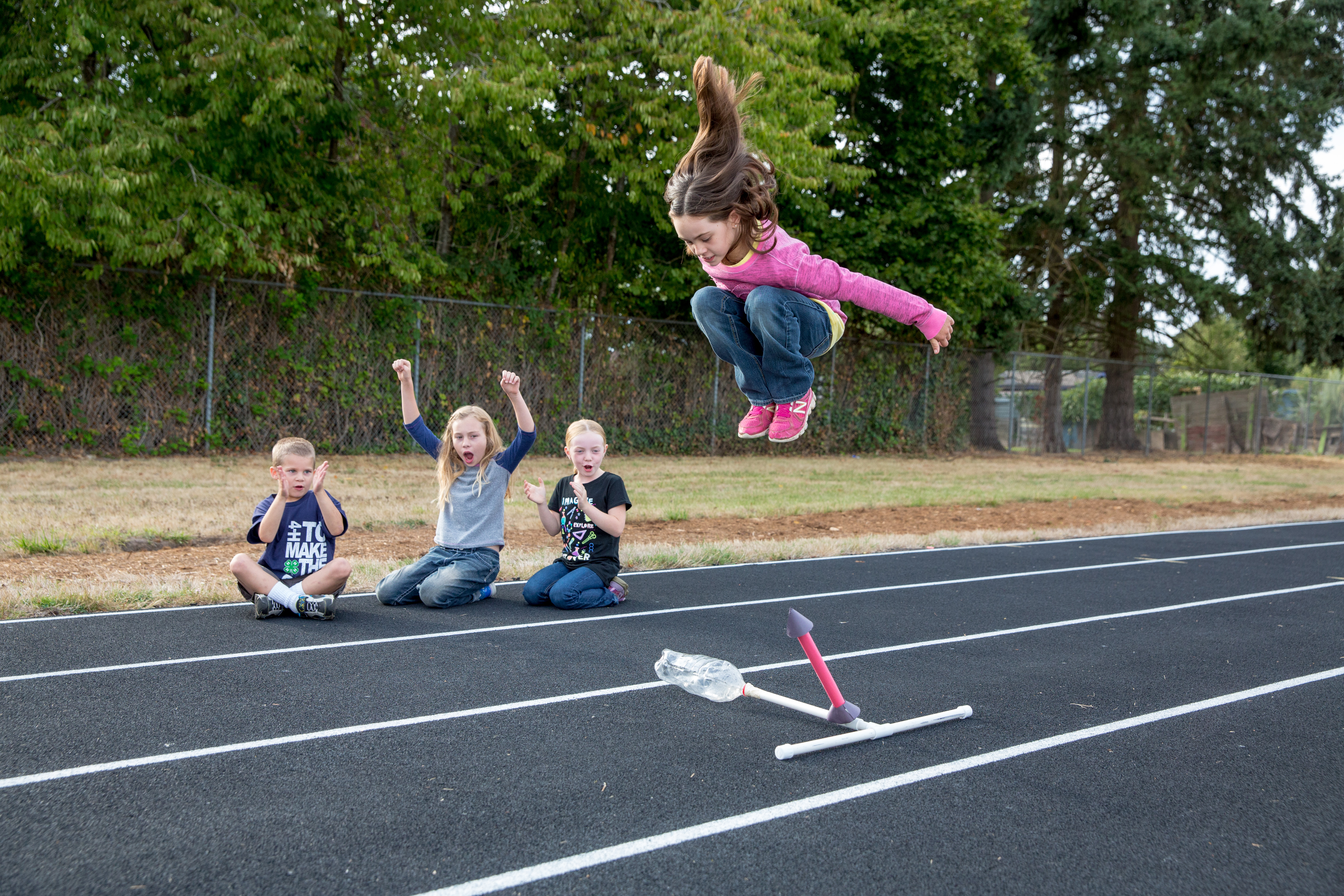 A child jumps on a soda bottle rocket launcher