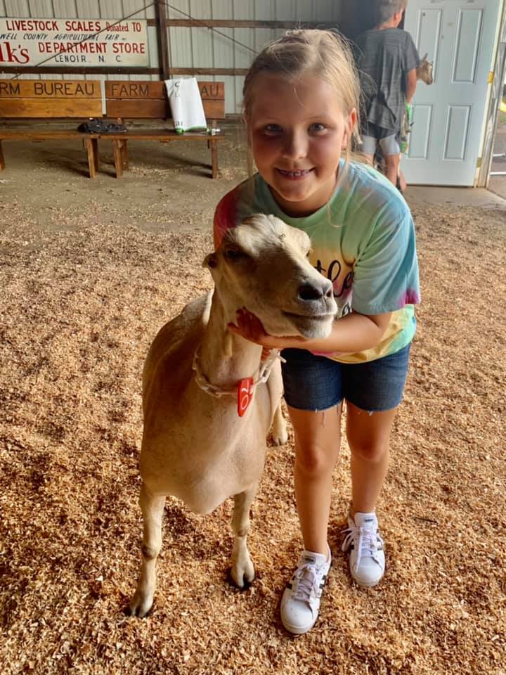 4-H member Peyton practices goat showmanship.