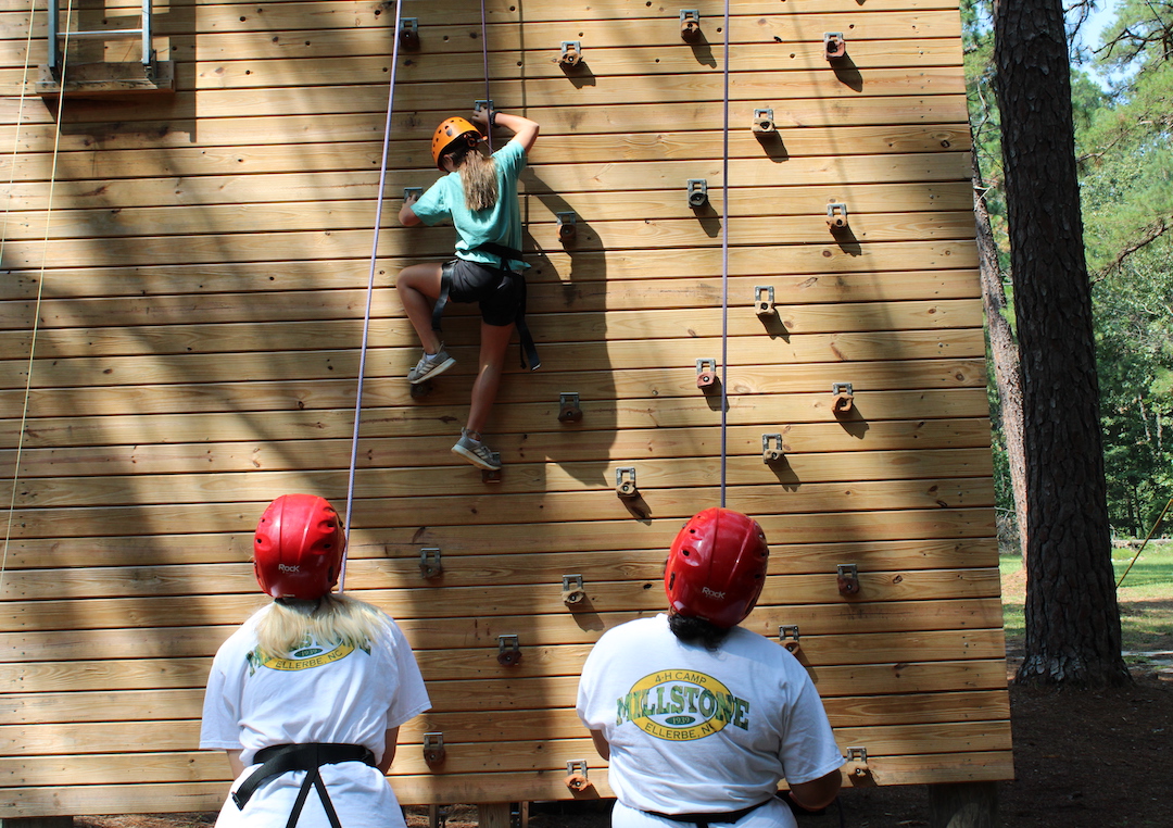 A camper at Millstone 4-H Camp tries scaling the climbing wall.