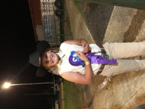 Alyssa Snyder beams after winning the champion dairy goat award at the 2021 fair. This was her first time participating.