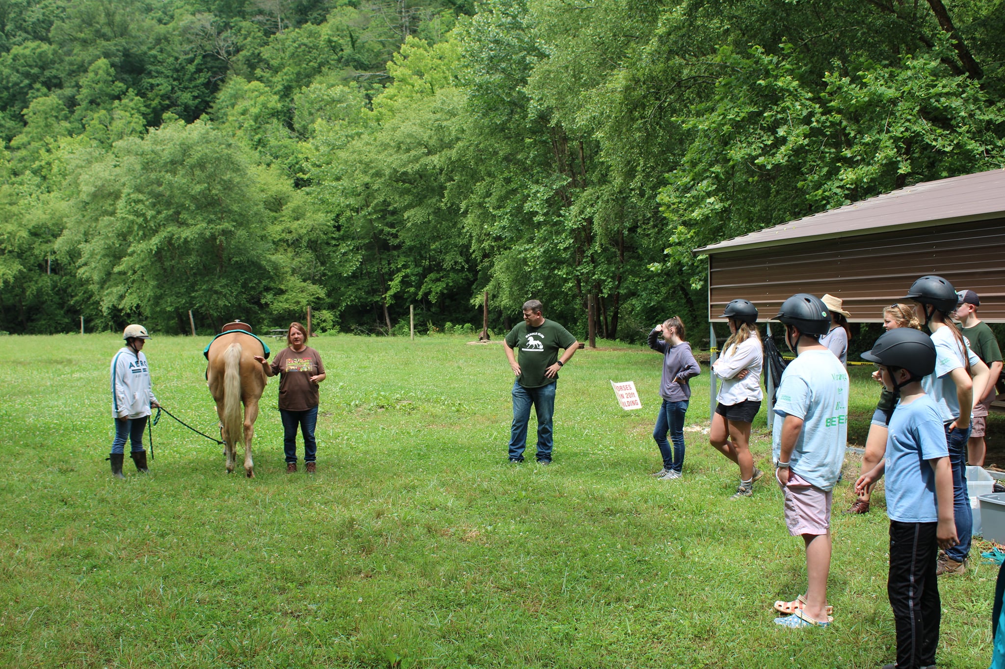 Youth and volunteers listen to instructions during a 2021 4-H program at Anita Alta.