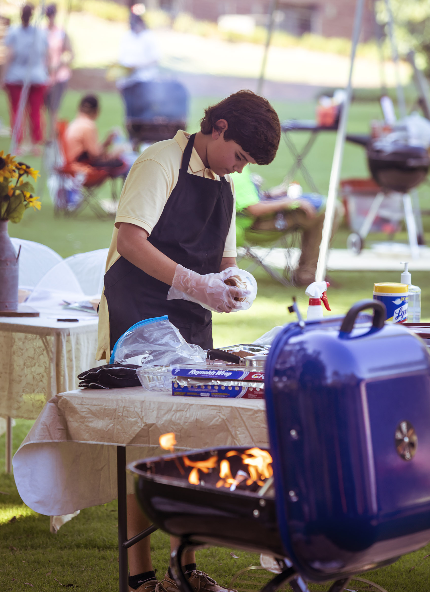 Photo by Ken Martin - Boy preparing to grill.