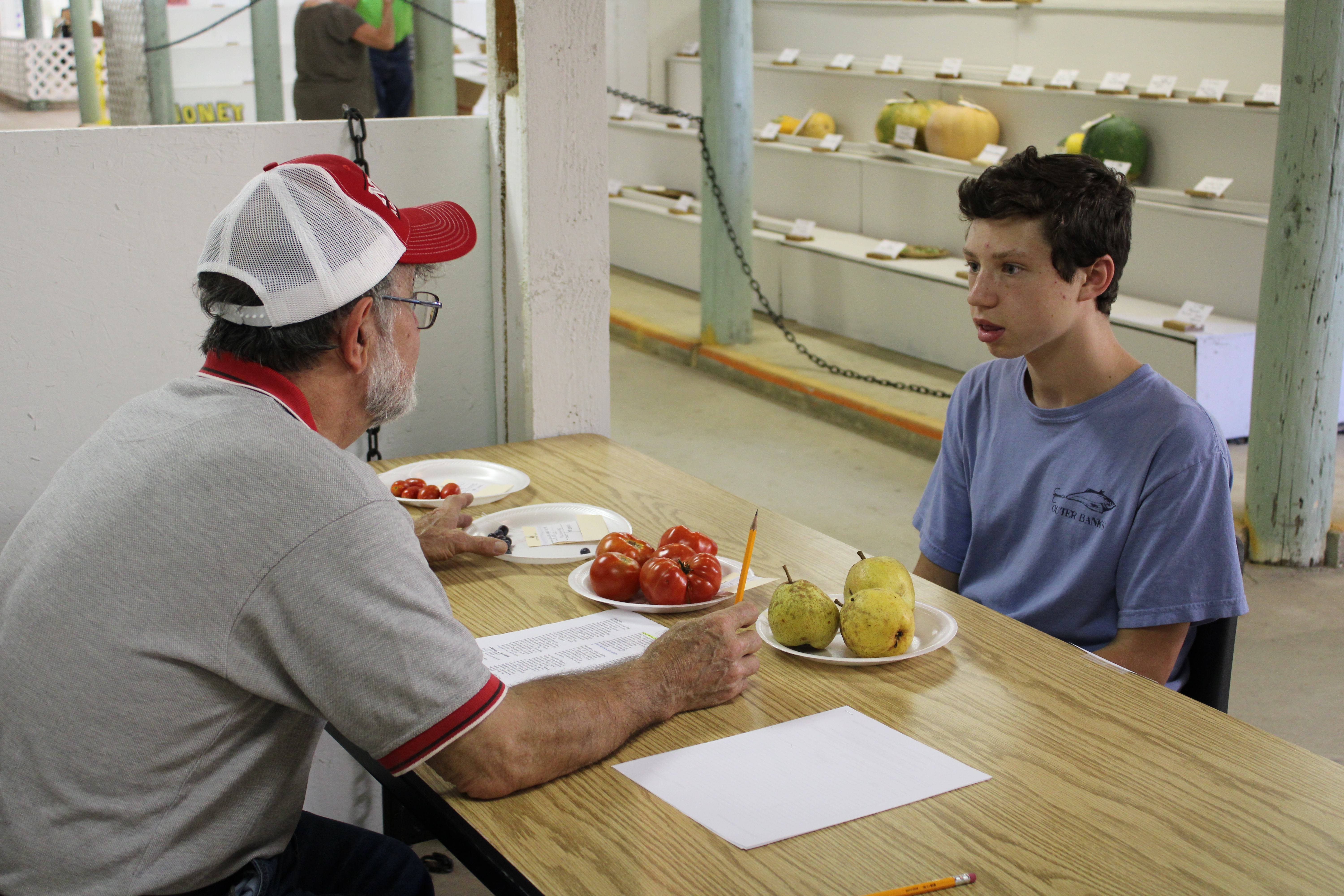 A judge speaks with a youth exhibitor during conference judging in 2019.