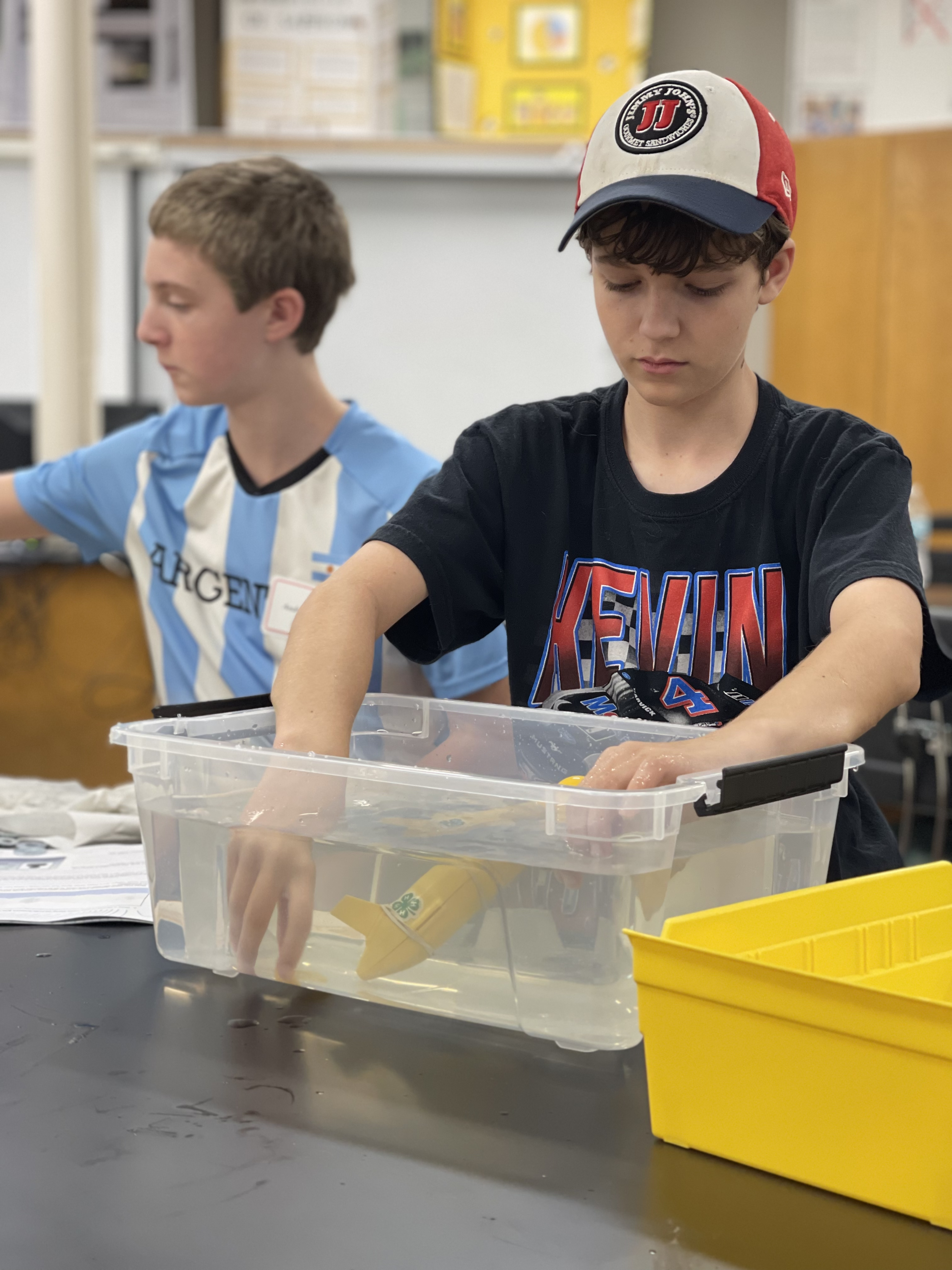 Will Perry works to ballast his ocean robot model during 4-H STEM Night on October 13 at CCC&TI. Ballasting involves adding or removing weights to vessels to change their buoyancy.