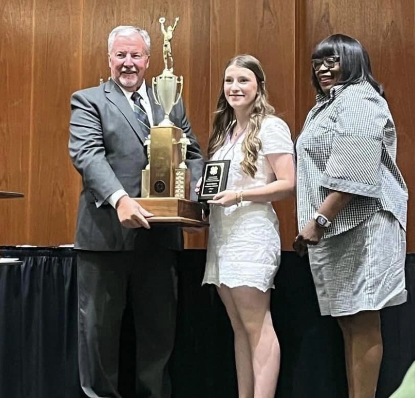 Addi Dillion receives the Commissioner James A. Graham 4-H Agriculture Trophy for her excellent work in agriculture and livestock at the 4-H Youth and Donor Luncheon