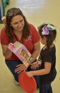 Adults showing a child a nutrition flyer