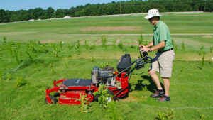 man mowing field
