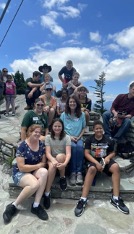 kids sitting on a rock