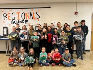 kids holding the blankets they made