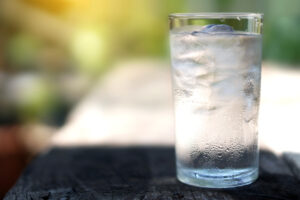 a glass with ice and water in it