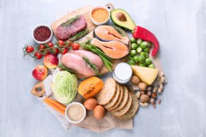 raw chicken, salmon, steak, cabbage, tomatos, squash, avocado with cheese, olives, nuts, apples